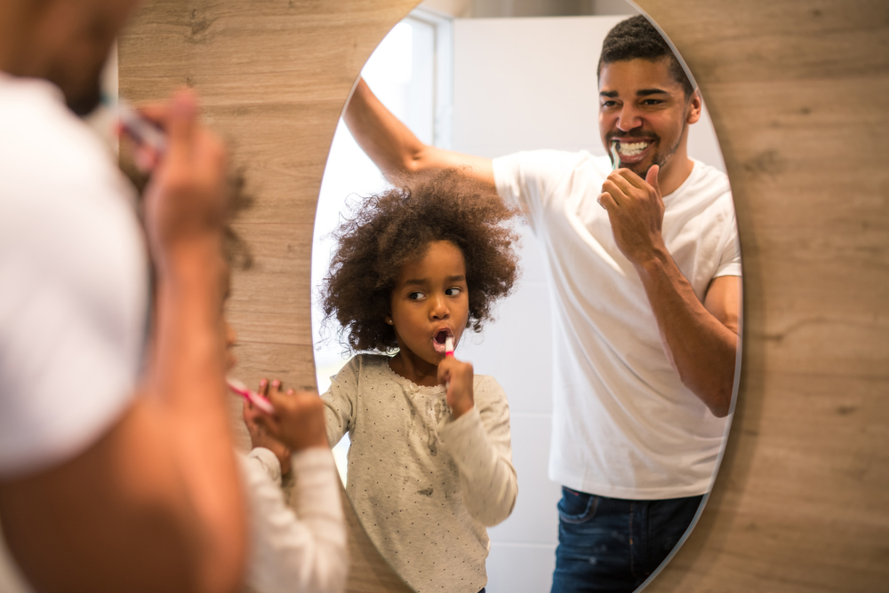 parent and child brushing teeth